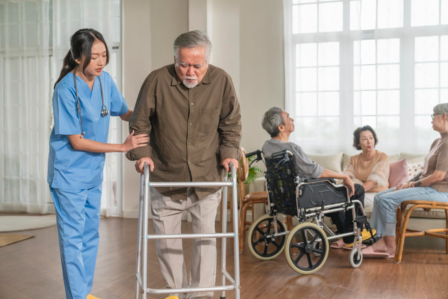 Caring caregiver with elderly patient at home